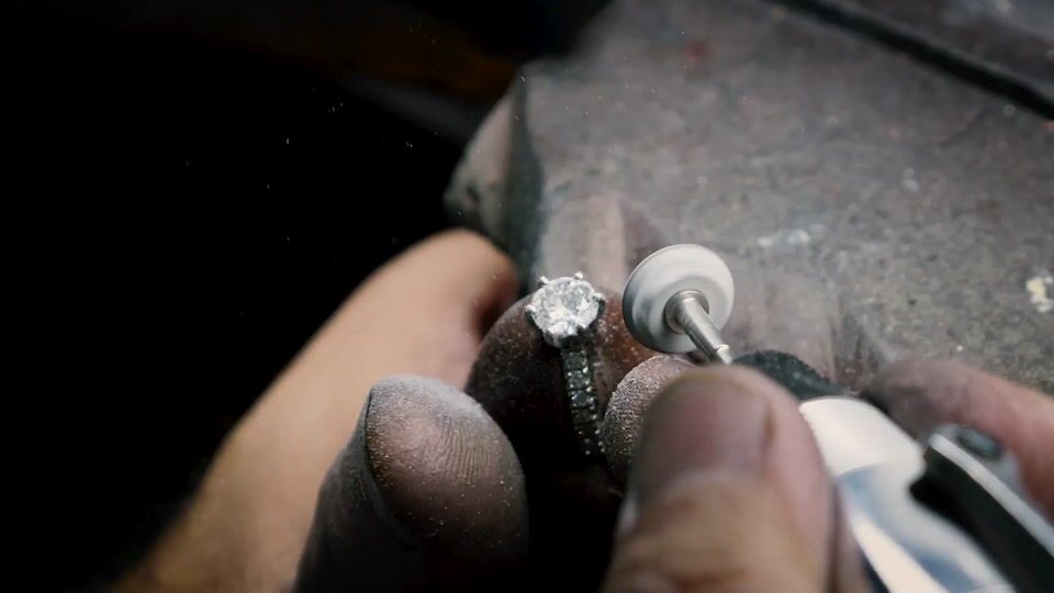 A jeweller finishing a ring with a rotary tool at Anny's workshop